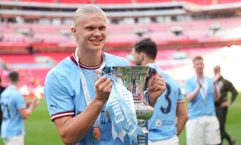Erling Haaland of Manchester City celebrates with the FA Cup Trophy after the team's victory during the Emirates FA Cup Final between City and Manchester United at Wembley Stadium. if he plays in the FA Cup semi-finals, he'll be looking to strike gold.