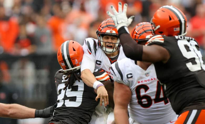 CLEVELAND, OH - SEPTEMBER 10: Cincinnati Bengals quarterback Joe Burrow (9) is hit by Cleveland Browns defensive end Za'Darius Smith (99) after throwing a pass during the third quarter of the National Football League game between the Cincinnati Bengals and Cleveland Browns on September 10, 2023, at Cleveland Browns Stadium in Cleveland, OH.