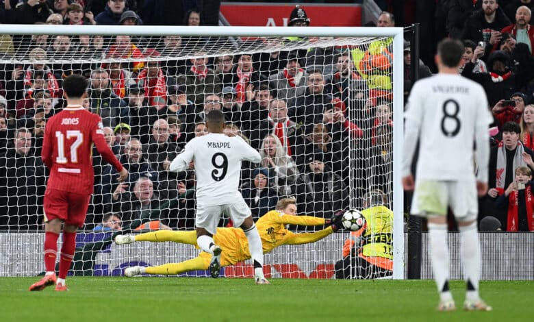 Caoimhin Kelleher of Liverpool saves a penalty from Kylian Mbappe of Real Madrid during the UEFA Champions League 2024/25 League Phase MD5 match between Liverpool FC and Real Madrid C.F. at Anfield on November 27, 2024 in Liverpool, England.
