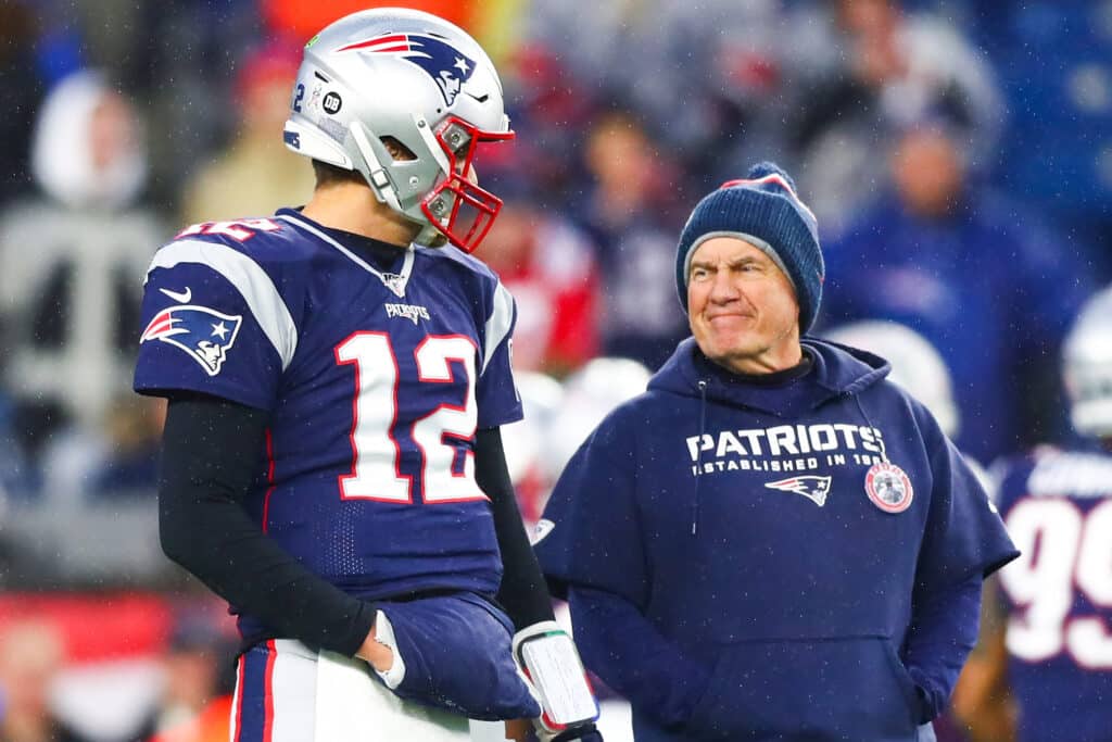 Tom Brady #12 talks to head coach Bill Belichick of the New England Patriots