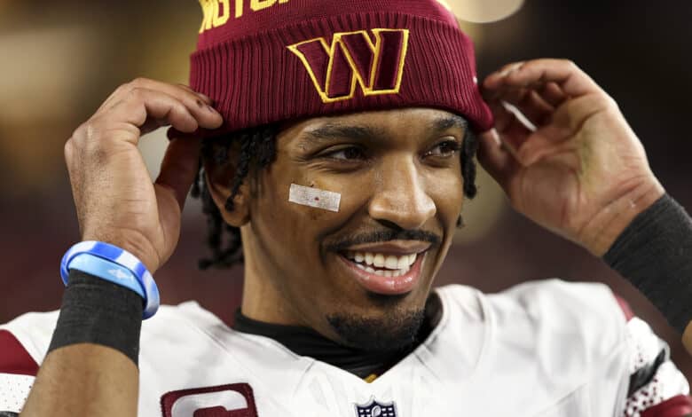 Jayden Daniels #5 of the Washington Commanders smiles after an NFL football wild card playoff game against the Tampa Bay Buccaneers