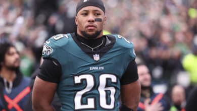 Saquon Barkley #26 of the Philadelphia Eagles stands on the field in the NFC Championship Game against the Washington Commanders