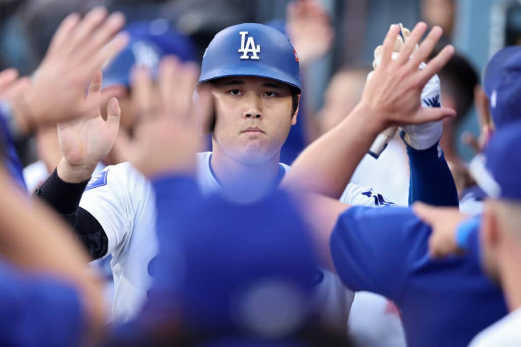 LOS ANGELES, CALIFORNIA - OCTOBER 20: Shohei Ohtani #17 of the Los Angeles Dodgers is congratulated by teammates in the dugout after scoring on a double by Tommy Edman #25 during the 1st inning of Game Six of the National League Championship Series against the New York Mets at Dodger Stadium on October 20, 2024 in Los Angeles, California