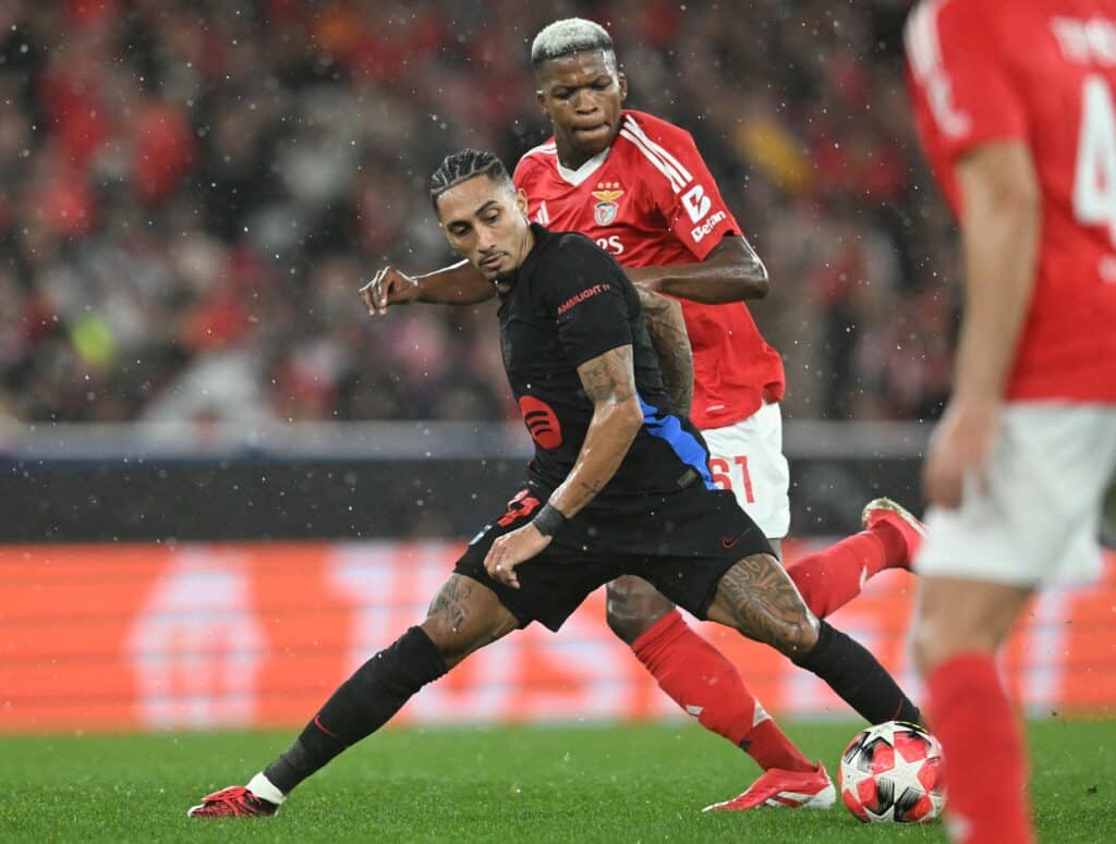 Raphinha fights for the ball with Benfica's Portuguese midfielder Florentino Luis during the UEFA Champions League, league phase football match between SL Benfica and FC Barcelona at Luz stadium in Lisbon on January 21, 2025.