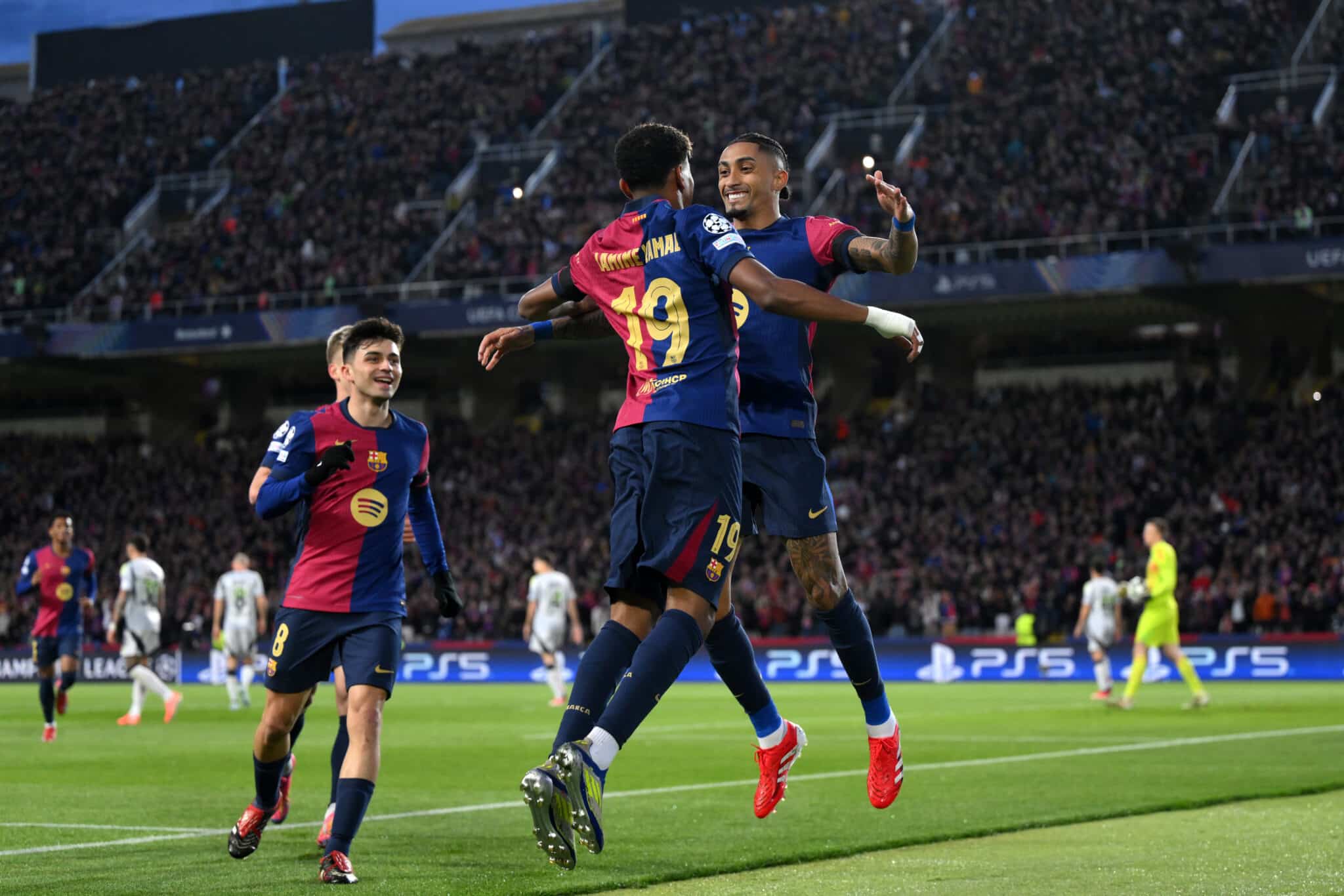 Raphinha of FC Barcelona celebrates scoring his team's first goal with teammate Lamine Yamal during the UEFA Champions League 2024/25 UEFA Champions League 2024/25 Round of 16 Second Leg match between FC Barcelona and SL Benfica at Estadi Olímpic Lluís Companys on March 11, 2025 in Barcelona, Spain.
