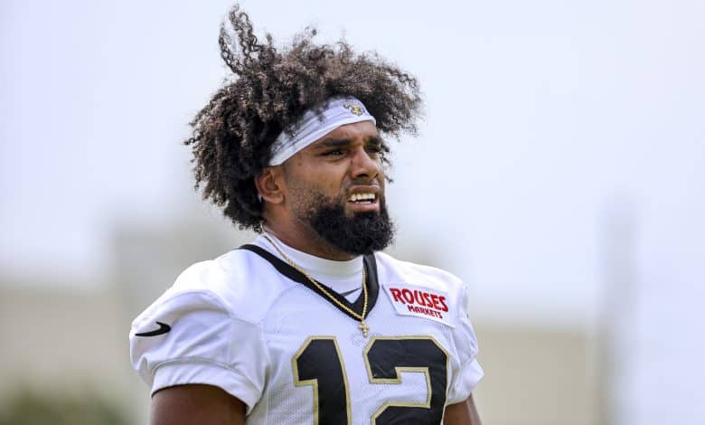 METAIRIE, LOUISIANA - JULY 24: Chris Olave #12 of the New Orleans Saints looks on from the field during a training camp practice at the Ochsner Sports Performance Center on July 24, 2025 in Metairie, Louisiana.