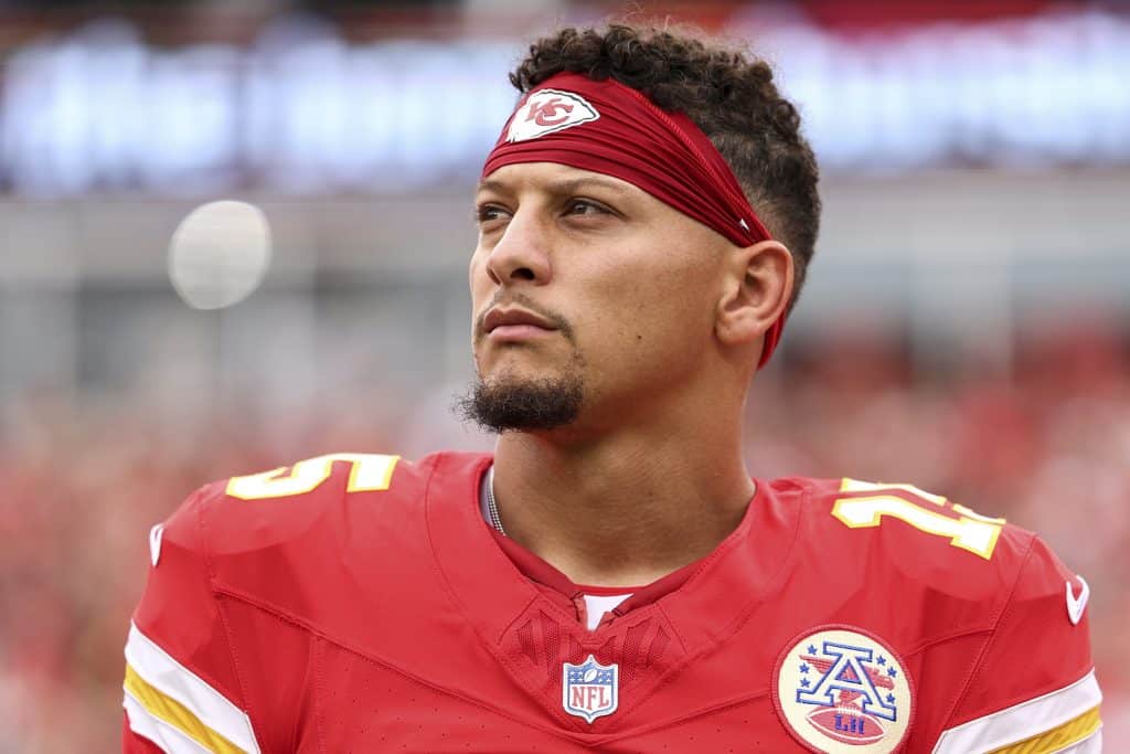 KANSAS CITY, MISSOURI - SEPTEMBER 14: Patrick Mahomes #15 of the Kansas City Chiefs stands on the sideline during the national anthem prior to an NFL football game against the Philadelphia Eagles at GEHA Field at Arrowhead Stadium on September 14, 2025 in Kansas City, Missouri.