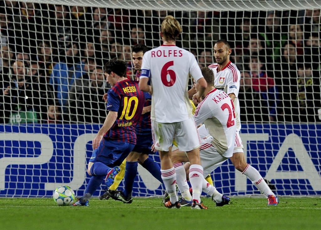 FC Barcelona's Argentinian forward Lionel Messi (L) scores during the Champions League round of sixteen second leg football match between FC Barcelona vs Bayer 04 Leverkusen on March 7, 2012 at the Camp Nou stadium in Barcelona. 