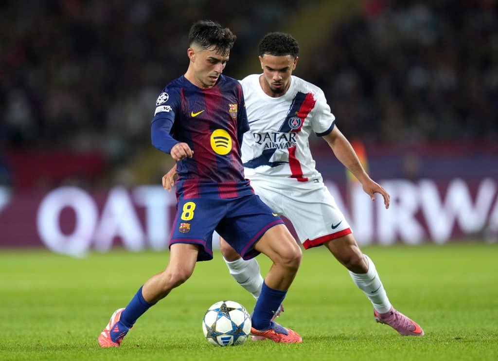 BARCELONA, SPAIN - OCTOBER 01: Pedri of FC Barcelona passes the ball whilst under pressure from Warren Zaire-Emery of Paris Saint-Germain during the UEFA Champions League 2025/26 League Phase MD2 match between FC Barcelona and Paris Saint-Germain at Estadi Olimpic Lluis Companys on October 01, 2025 in Barcelona, Spain. 