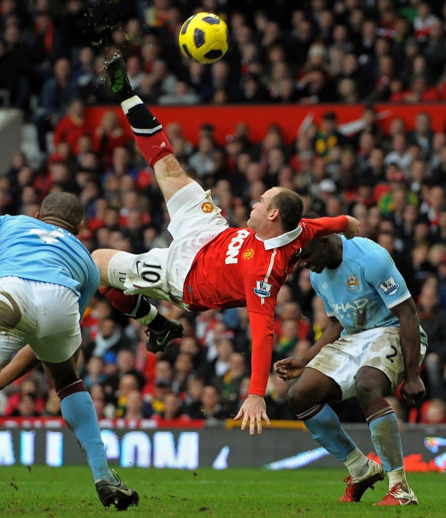 Manchester United's English striker Wayne Rooney (2nd L) scores their second goal during the English Premier League football match between Manchester United and Manchester City at Old Trafford in Manchester, north-west England on February 12, 2011. AFP PHOTO/ANDREW YATESRESTRICTED TO EDITORIAL USE Additional licence required for any commercial/promotional use or use on TV or internet (except identical online version of newspaper) of Premier League/Football League photos. Tel DataCo +44 207 2981656. Do not alter/modify photo