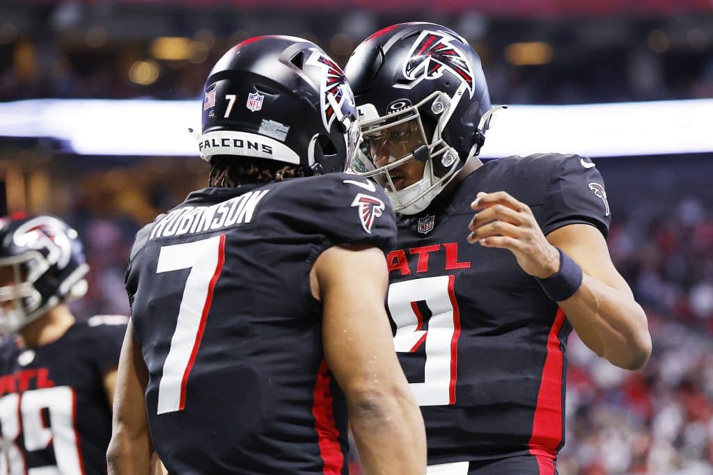 ATLANTA, GEORGIA - JANUARY 05: Bijan Robinson #7 of the Atlanta Falcons celebrates after scoring a rushing touchdown with teammate Michael Penix Jr. #9 during the second quarter against the Carolina Panthers at Mercedes-Benz Stadium on January 05, 2025 in Atlanta, Georgia. 