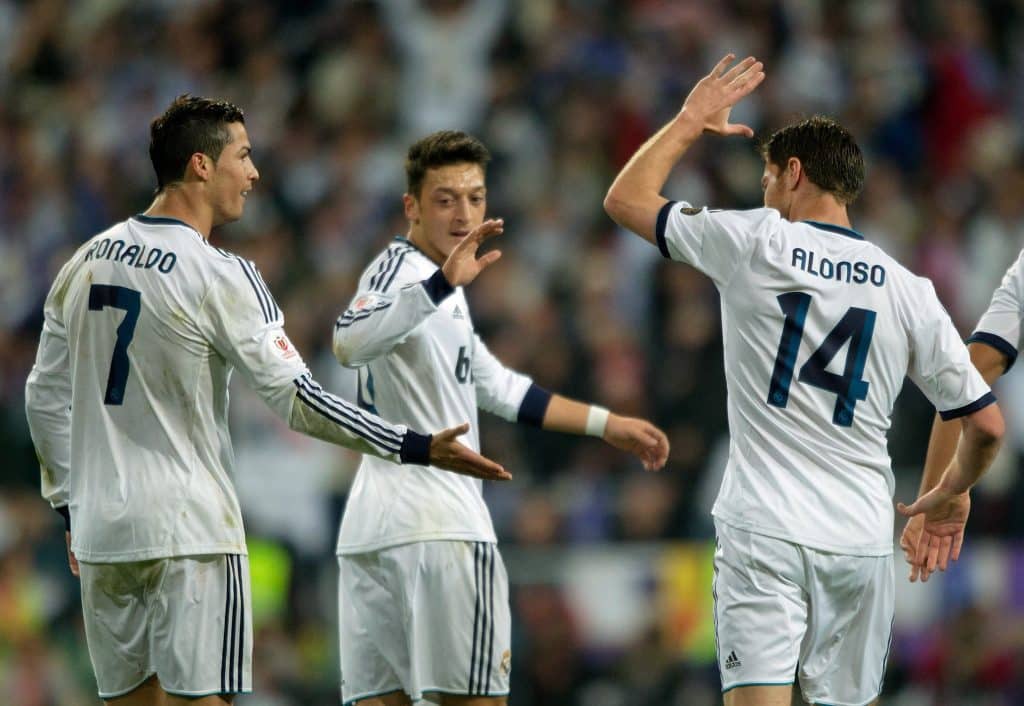 MADRID, SPAIN - MAY 17: Cristiano Ronaldo (L) of Real Madrid CF celebrates with teammates Mesut Ozil (C) and Xabi Alonso (R) after scoring the opening goal during the Copa del Rey Final match between Real Madrid CF and Club Atletico de Madrid at Estadio Santiago Bernabeu on May 17, 2013 in Madrid, Spain.