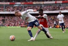 LONDON, ENGLAND - SEPTEMBER 24: James Maddison of Tottenham Hotspur is challenged by Bukayo Saka of Arsenal during the Premier League match between Arsenal FC and Tottenham Hotspur at Emirates Stadium on September 24, 2023 in London, England.