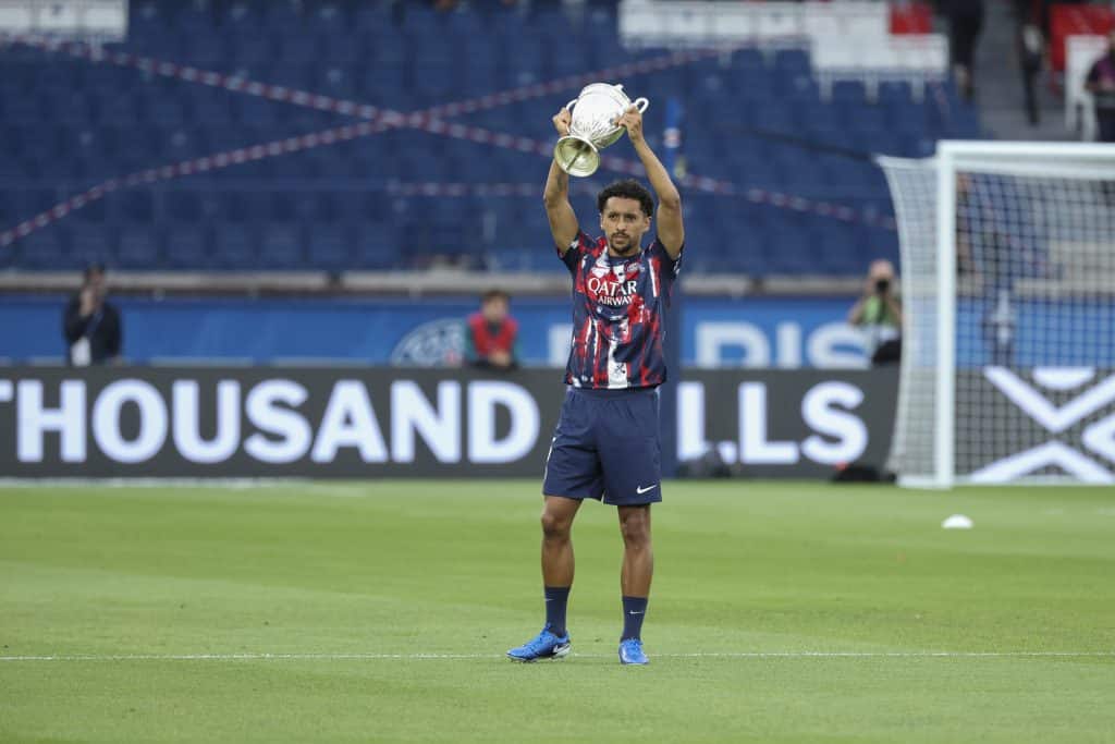 PARIS, FRANCE - AUGUST 23: Marquinhos #5 of Paris Saint-Germain shows the Coupe de France Trophy to the fans before the Ligue 1 match between Paris Saint-Germain and Montpellier HSC at Parc des Princes on August 23, 2024 in Paris, France.