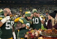 GREEN BAY, WISCONSIN - NOVEMBER 28: Quarterback Jordan Love #10 of the Green Bay Packers, linebacker Isaiah McDuffie #58, and running back Josh Jacobs #8 enjoy Thanksgiving turkey with NBC Sports reporter Melissa Stark after an NFL football game against the Miami Dolphins, at Lambeau Field on November 28, 2024 in Green Bay, Wisconsin.