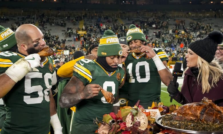 GREEN BAY, WISCONSIN - NOVEMBER 28: Quarterback Jordan Love #10 of the Green Bay Packers, linebacker Isaiah McDuffie #58, and running back Josh Jacobs #8 enjoy Thanksgiving turkey with NBC Sports reporter Melissa Stark after an NFL football game against the Miami Dolphins, at Lambeau Field on November 28, 2024 in Green Bay, Wisconsin.