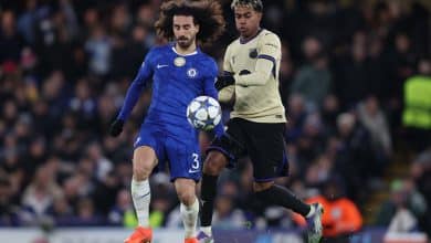 Marc Cucurella of Chelsea battles for the ball with Lamine Yamal of Barcelona