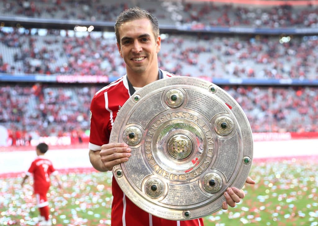 MUNICH, GERMANY - MAY 20:  Philipp Lahm of Bayern Muenchen poses with the Championship trophy in celebration of the 67th German Championship title following the Bundesliga match between Bayern Muenchen and SC Freiburg at Allianz Arena on May 20, 2017 in Munich, Germany.  