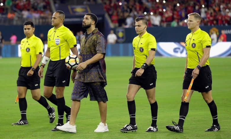 Rapper/Singer Drake brings out the game ball with the officials at NRG Stadium