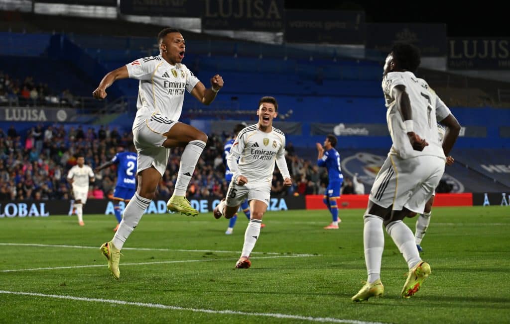Kylian Mbappe of Real Madrid celebrates scoring his team's first goal with teammates Arda Gueler and Vinicius Junior during the LaLiga EA Sports match between Getafe CF and Real Madrid CF at Coliseum Alfonso Perez on October 19, 2025 in Getafe, Spain. 