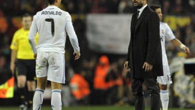 Real Madrid's Portuguese forward Cristiano Ronaldo (L) watches Barcelona's coach Josep Guardiola during the Spanish league "clasico" football match FC Barcelona vs Real Madrid at Camp Nou stadium on November 29, 2010 in Barcelona. Barcelona won 5-0. AFP PHOTO/ JAVIER SORIANO