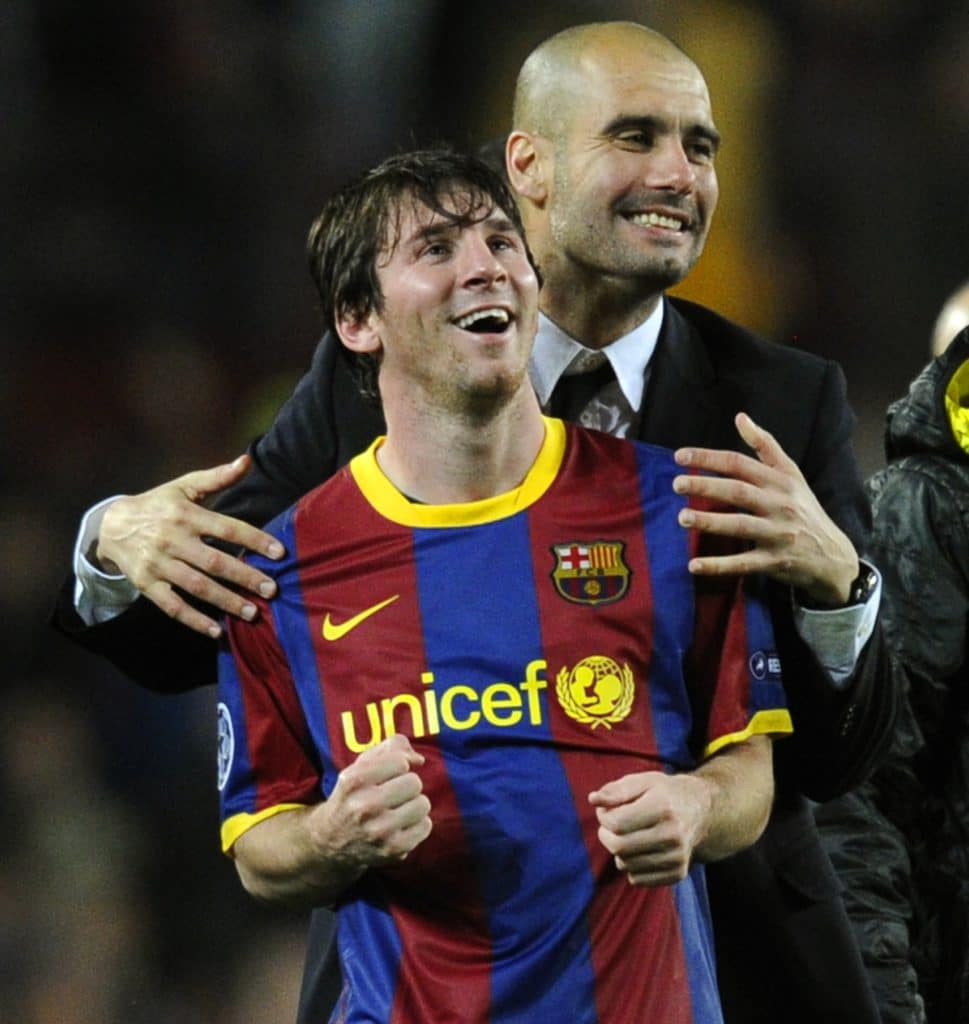 Barcelona's coach Josep Guardiola (R) celebrates with Barcelona's Argentinian forward Lionel Messi after  the Champions League semi-final second leg football match between Barcelona and Real Madrid at the Camp Nou stadium in Barcelona on May 3, 2011. Barcelona qualified for the Champions League final after drawing 1-1 in their semi-final second leg clash with bitter rivals Real Madrid to progress 3-1 on aggregate.  AFP PHOTO/JAVIER SORIANO 