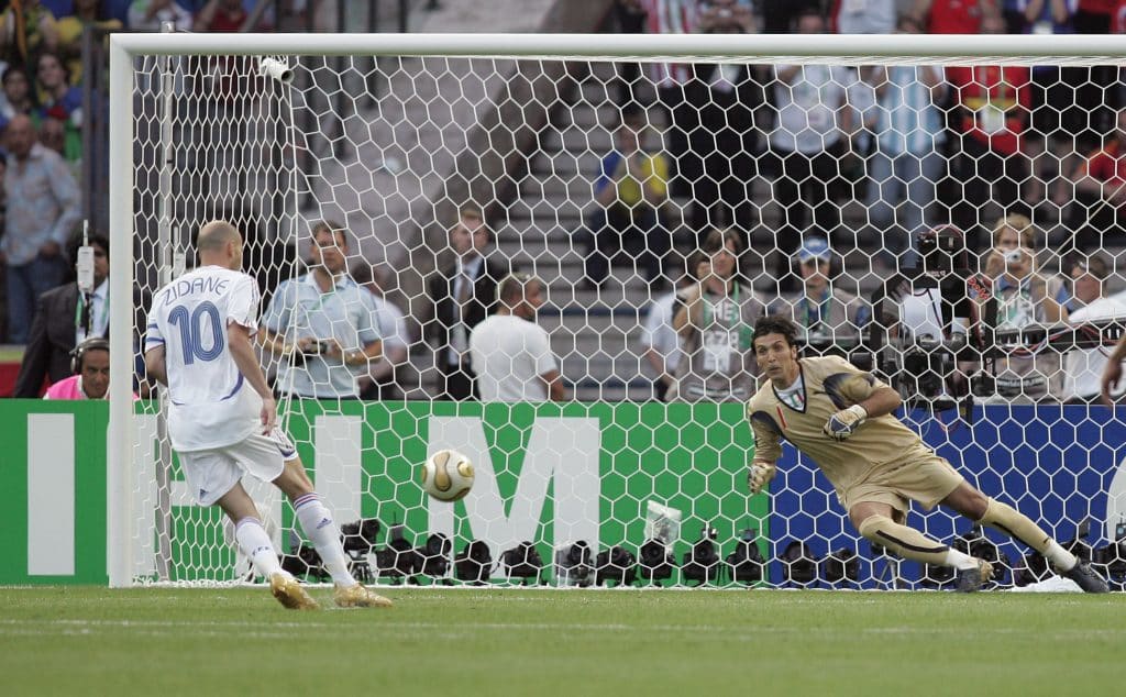 Zinedine Zidane of France chips the ball past Italian goalkeeper Gianluigi Buffon to score for France from the penalty spot in the World Cup final.