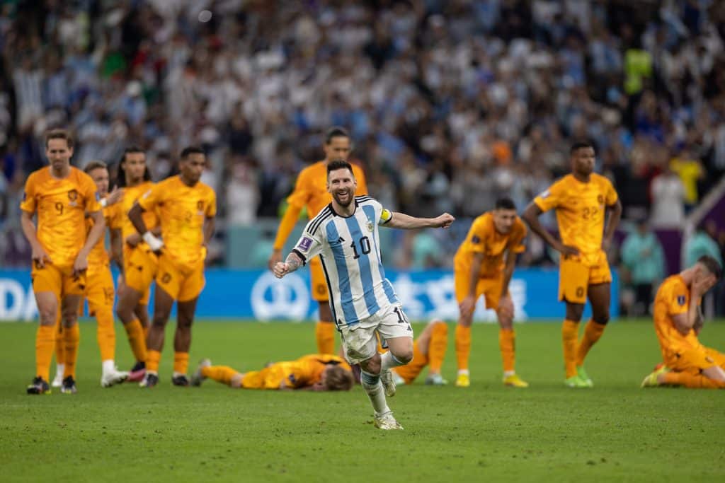 LUSAIL CITY, QATAR - DECEMBER 09:: Lionel Messi of Argentina celebrates in front of the dejected Netherlands players as Argentina win on penalties during the FIFA World Cup Qatar 2022 quarter final match between Netherlands (2) and Argentina (2) (Argentina win 4-3 on penalties) at Lusail Stadium on December 09, 2022 in Lusail City, Qatar.