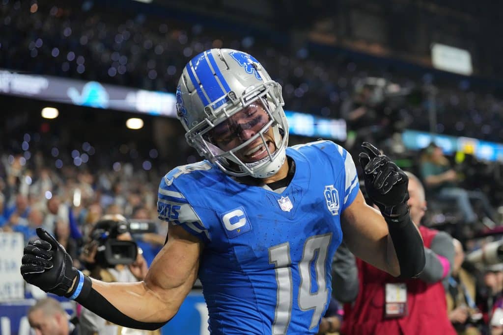 Amon-Ra St. Brown #14 of the Detroit Lions celebrates a touchdown against the Tampa Bay Buccaneers during the fourth quarter of the NFC Divisional Playoff game at Ford Field on January 21, 2024 in Detroit, Michigan. 