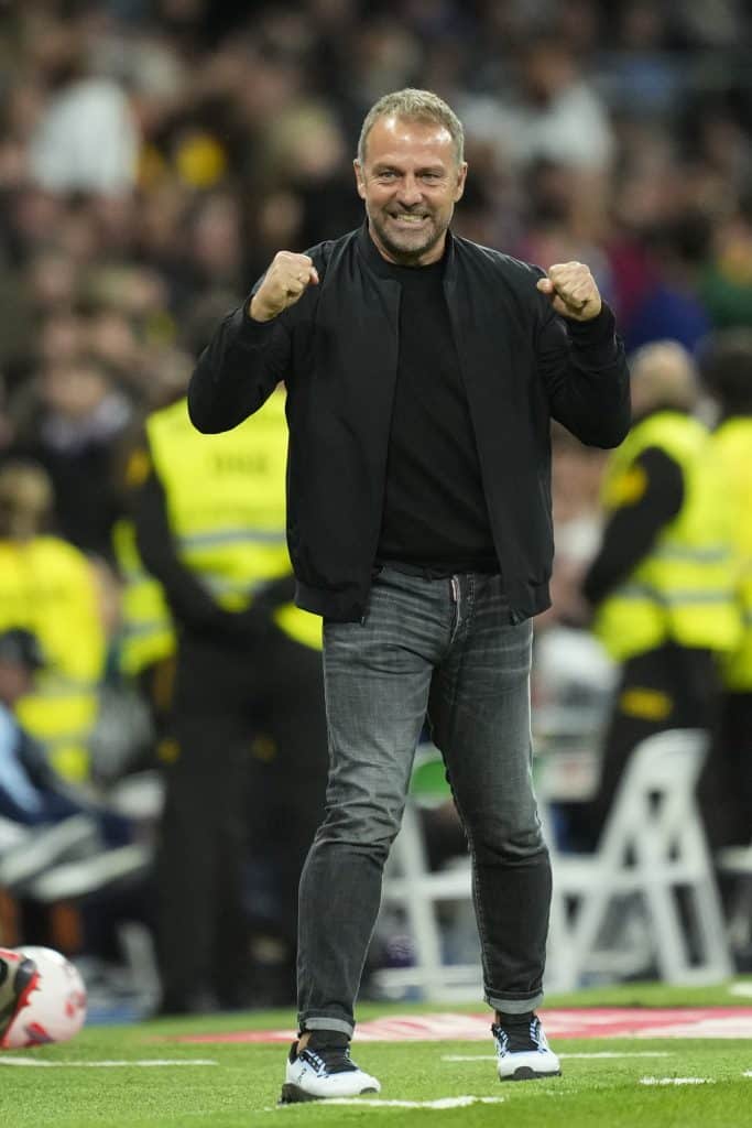 Hansi Flick head coach of Barcelona celebrates the goal of his team during the La Liga match between Real Madrid CF and FC Barcelona at Estadio Santiago Bernabeu on October 27, 2024 in Madrid, Spain. 