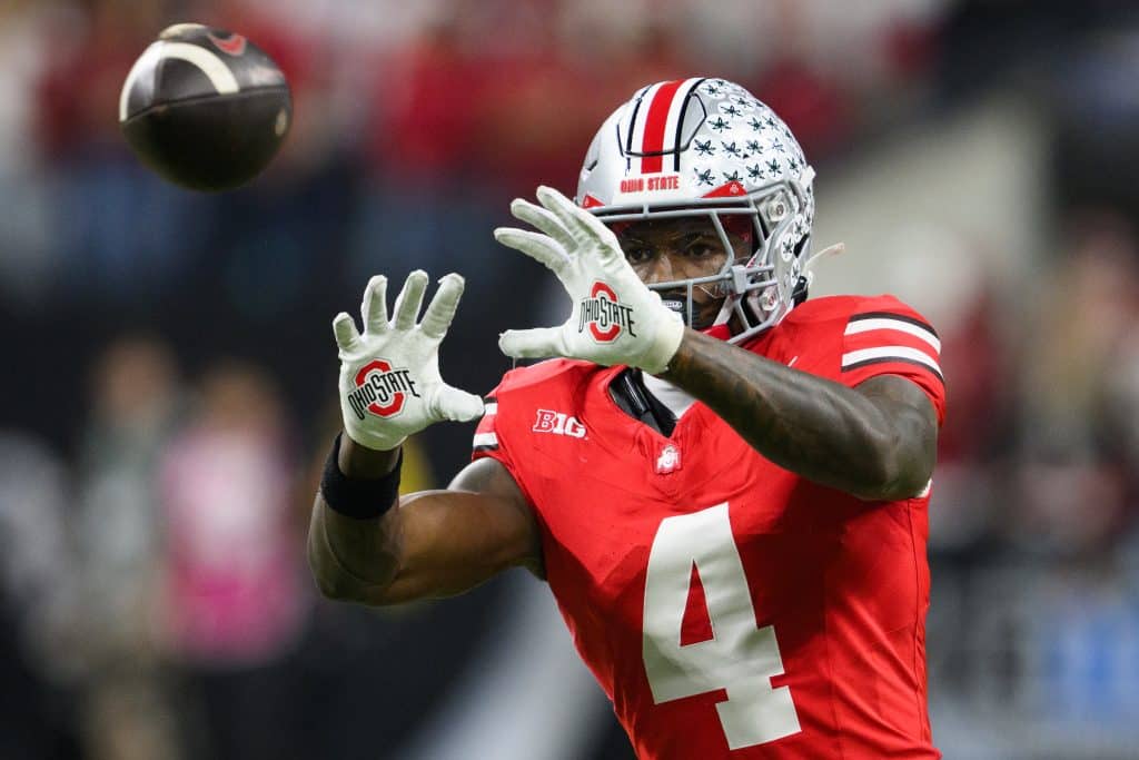INDIANAPOLIS, IN - DECEMBER 06: Ohio State Buckeyes wide receiver Jeremiah Smith (4) warms up on the field during the Big 10 Championship game between the Ohio State Buckeyes and Indiana Hoosiers on December 6, 2025, at Lucas Oil Stadium in Indianapolis, IN.