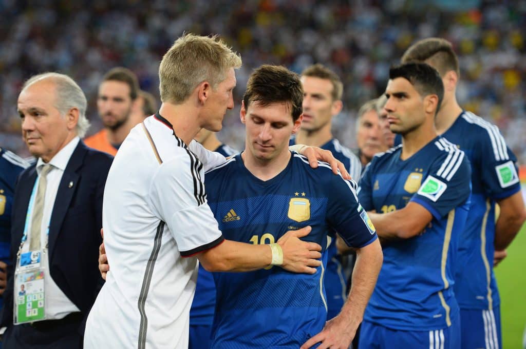 RIO DE JANEIRO, BRAZIL - JULY 13: Bastian Schweinsteiger of Germany consoles Lionel Messi of Argentina after Germany's 1-0 victory in extra time during the 2014 FIFA World Cup Brazil Final match between Germany and Argentina at Maracana on July 13, 2014 in Rio de Janeiro, Brazil.