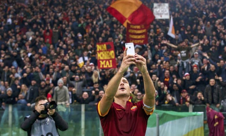 Francesco Totti of AS Roma selfie Apple iPhone during the Serie A match between AS Roma and Lazio Roma on January 11,2014 at the Stadio Olimpico in Rome, Italy.