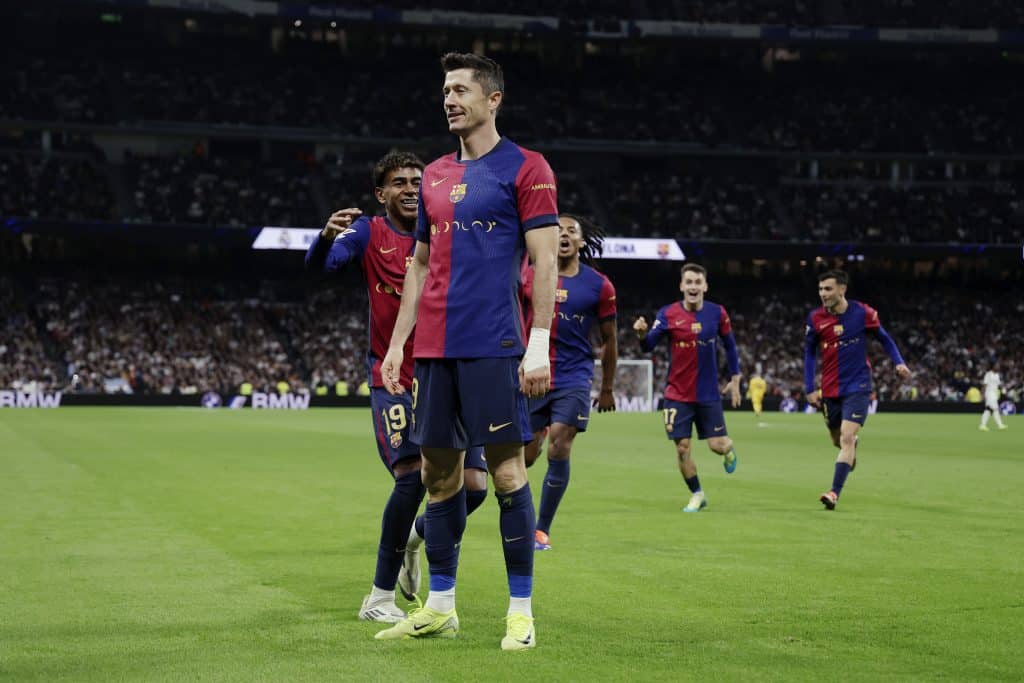 Robert Lewandowski of FC Barcelona celebrates 0-1 with Lamine Yamal of FC Barcelona, Jules Kounde of FC Barcelona  during the LaLiga EA Sports  match between Real Madrid v FC Barcelona at the Estadio Santiago Bernabeu on October 26, 2024 in Madrid Spain 