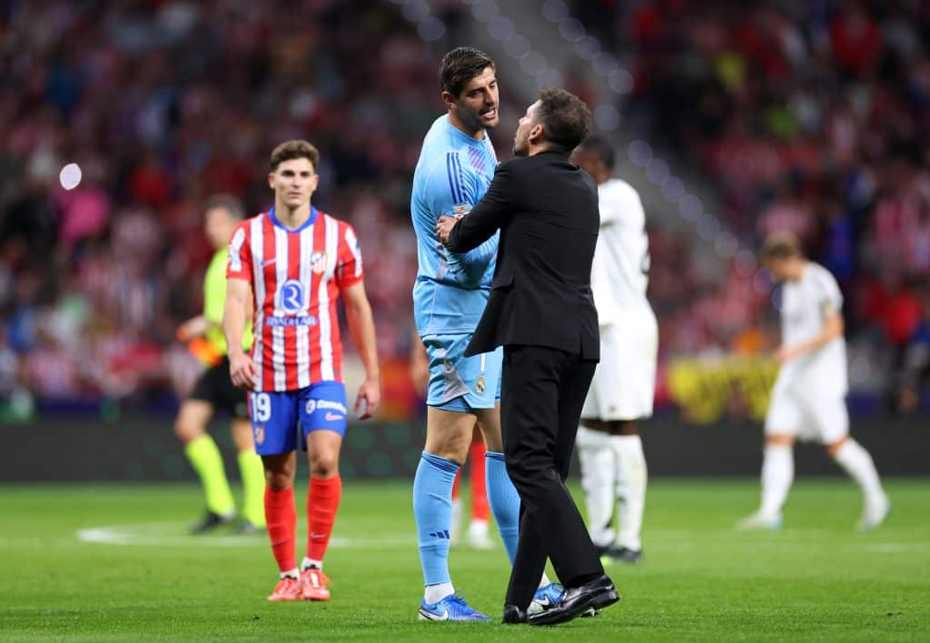 MADRID, SPAIN - SEPTEMBER 29: Thibaut Courtois of Real Madrid interacts with Diego Simeone, Head Coach of Atletico de Madrid, during the LaLiga match between Atletico de Madrid and Real Madrid CF  at Estadio Civitas Metropolitano on September 29, 2024 in Madrid, Spain.