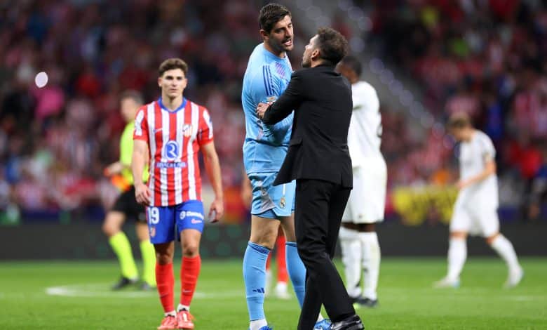 MADRID, SPAIN - SEPTEMBER 29: Thibaut Courtois of Real Madrid interacts with Diego Simeone, Head Coach of Atletico de Madrid, during the LaLiga match between Atletico de Madrid and Real Madrid CF at Estadio Civitas Metropolitano on September 29, 2024 in Madrid, Spain.