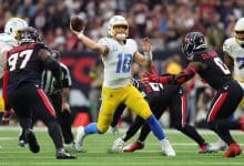 HOUSTON, TEXAS - JANUARY 11: Justin Herbert #10 of the Los Angeles Chargers passes against the Houston Texans during the AFC Wild Card Playoffs at NRG Stadium on January 11, 2025 in Houston, Texas.