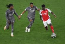 LONDON, ENGLAND - APRIL 08: Bukayo Saka of Arsenal runs with the ball under pressure from Eduardo Camavinga and David Alaba of Real Madrid during the UEFA Champions League 2024/25 Quarter Final First Leg match between Arsenal FC and Real Madrid C.F. at Arsenal Stadium on April 08, 2025 in London, England.