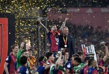 Barcelona's Spanish defender #05 Inigo Martinez Berridi (L) and Barcelona's German coach Hans-Dieter Flick (R) celebrate their victory with teammates after winning the Spanish Cup, Copa del Rey (King's Cup) final football match between FC Barcelona and Real Madrid CF at La Cartuja stadium in Seville on April 26, 2025.