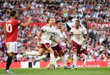 MANCHESTER, ENGLAND - AUGUST 17: Riccardo Calafiori of Arsenal celebrates scoring his team's first goal with William Saliba and Gabriel of Arsenal during the Premier League match between Manchester United and Arsenal at Old Trafford on August 17, 2025 in Manchester, England.