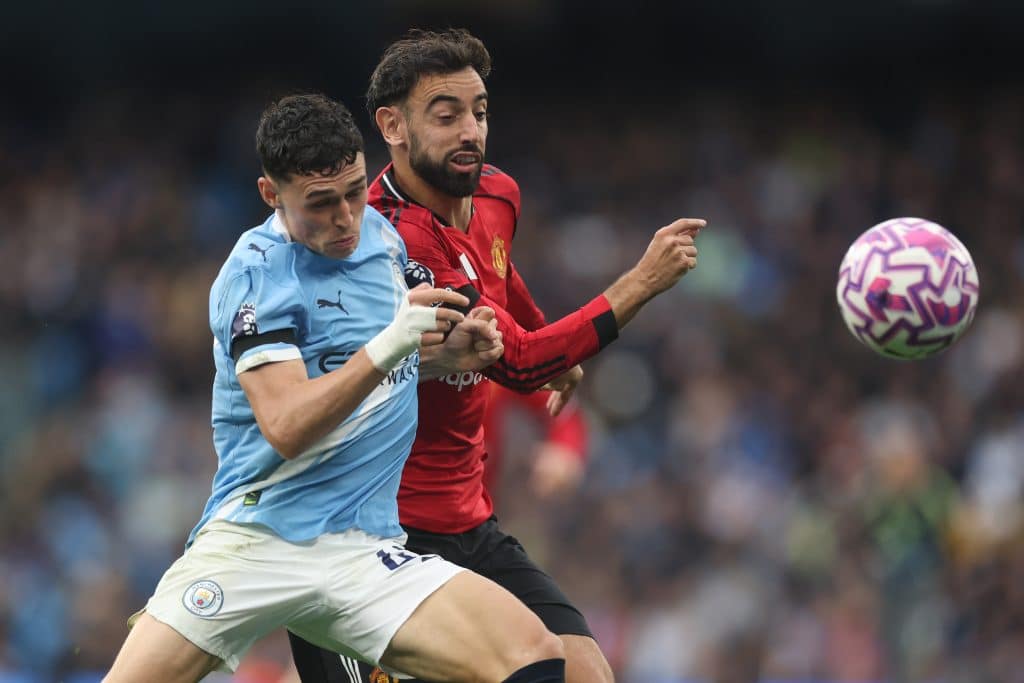 MANCHESTER, ENGLAND - SEPTEMBER 14: Phil Foden of Manchester City battles for possession with Bruno Fernandes of Manchester United during the Premier League match between Manchester City and Manchester United at Etihad Stadium on September 14, 2025 in Manchester, England. 