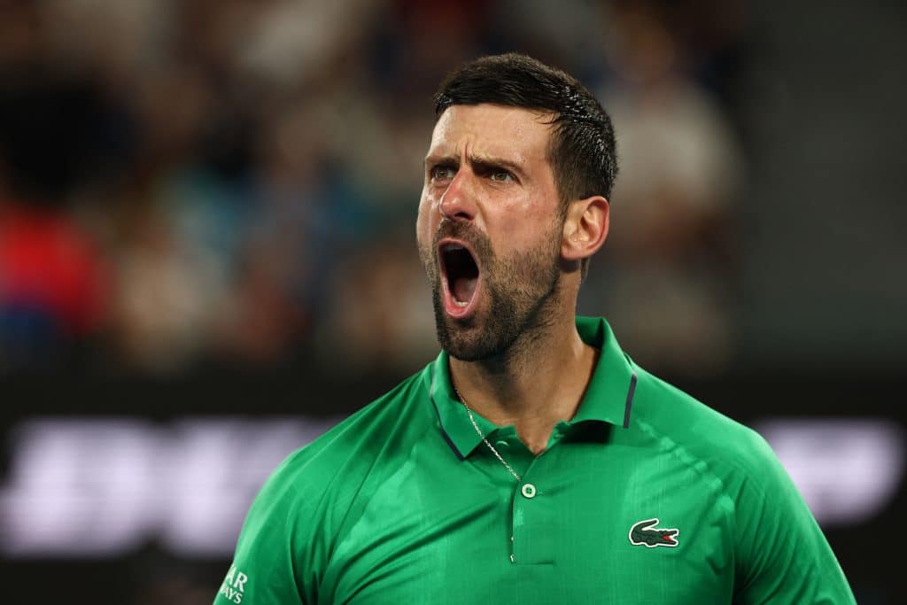 Serbia's Novak Djokovic reacts on a point to Italy's Jannik Sinner during their men's singles semi-final match on day thirteen of the Australian Open tennis tournament in Melbourne on January 31, 2026. 