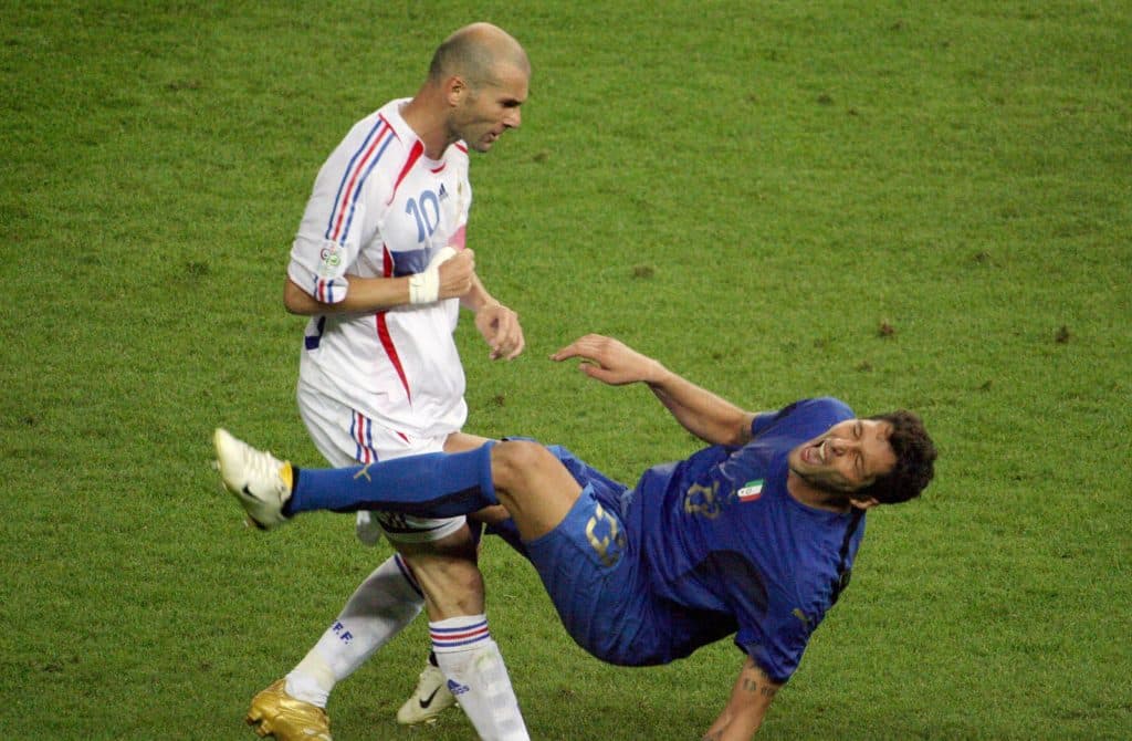 (FILES) This file picture taken on July 9, 2006 shows former France's midfielder Zinedine Zidane (L) gesturing after head-butting Italian defender Marco Materazzi during the World Cup 2006 final football match between Italy and France at Berlin?s Olympic Stadium in Germany. Italy's World Cup-winning defender Marco Materazzi on Monday April 7, 2008 accepted an apology and damages from a British newspaper over claims he used racist abuse to goad Zinedine Zidane into headbutting him. AFP PHOTO /JOHN MACDOUGALL/FILES 