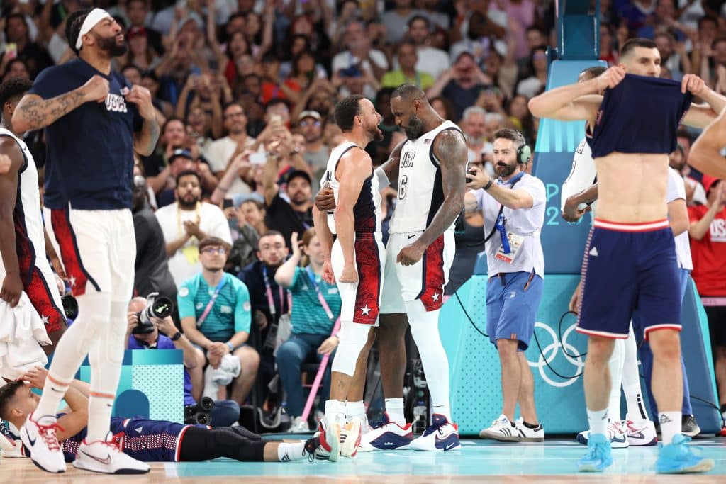 Lebron James #6 and Stephen Curry #4 of Team United States celebrate after winning a Men's basketball semifinals match between Team United States and Team Serbia.