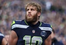 SEATTLE, WASHINGTON - JANUARY 25: Cooper Kupp #10 of the Seattle Seahawks stands on the sidelines during the national anthem prior to the NFC Championship NFL football game against the Los Angeles Rams at Lumen Field on January 25, 2026 in Seattle, Washington.