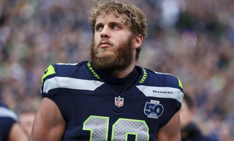SEATTLE, WASHINGTON - JANUARY 25: Cooper Kupp #10 of the Seattle Seahawks stands on the sidelines during the national anthem prior to the NFC Championship NFL football game against the Los Angeles Rams at Lumen Field on January 25, 2026 in Seattle, Washington.